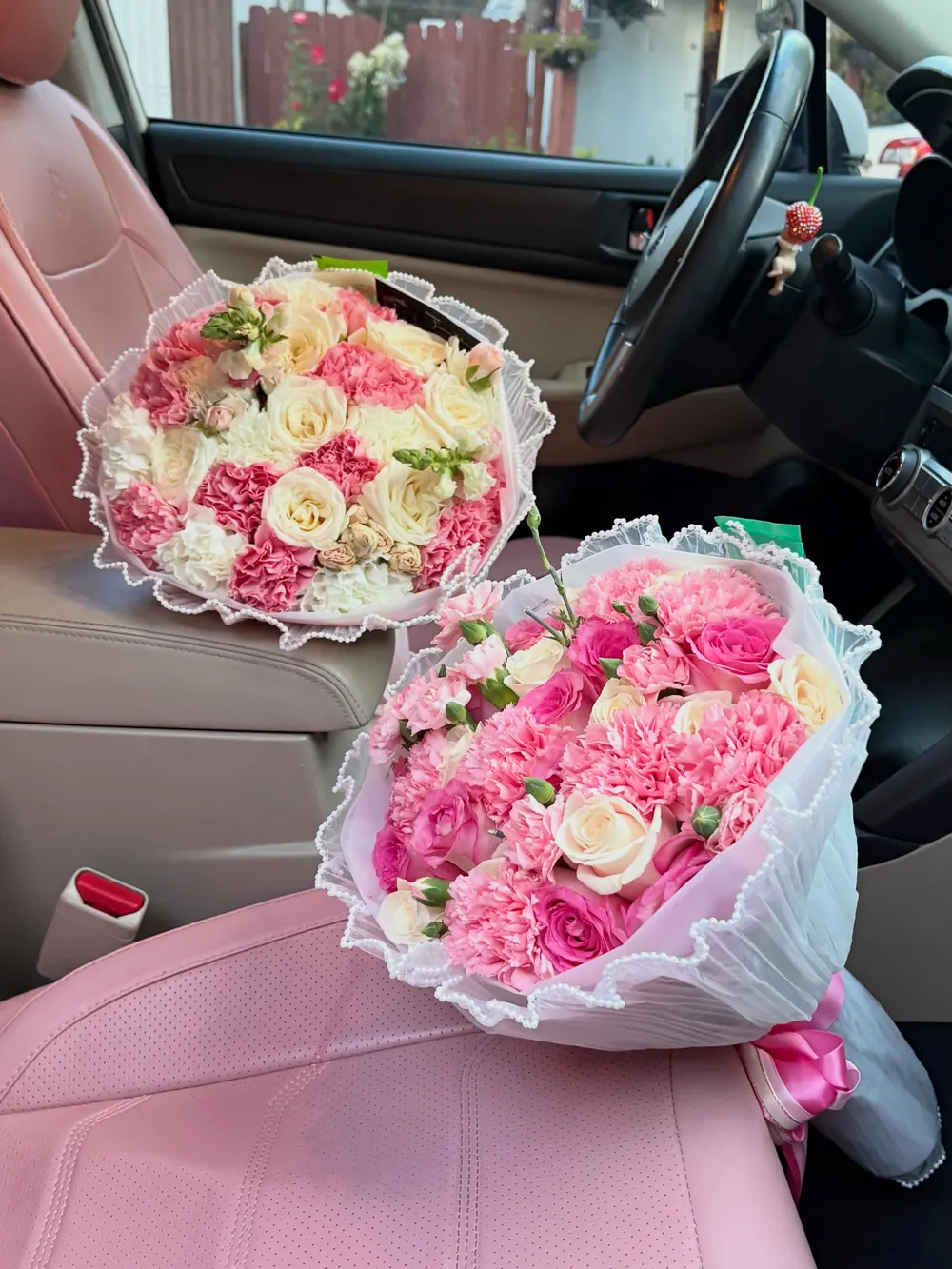 Two pink and cream rose and carnation bouquets
