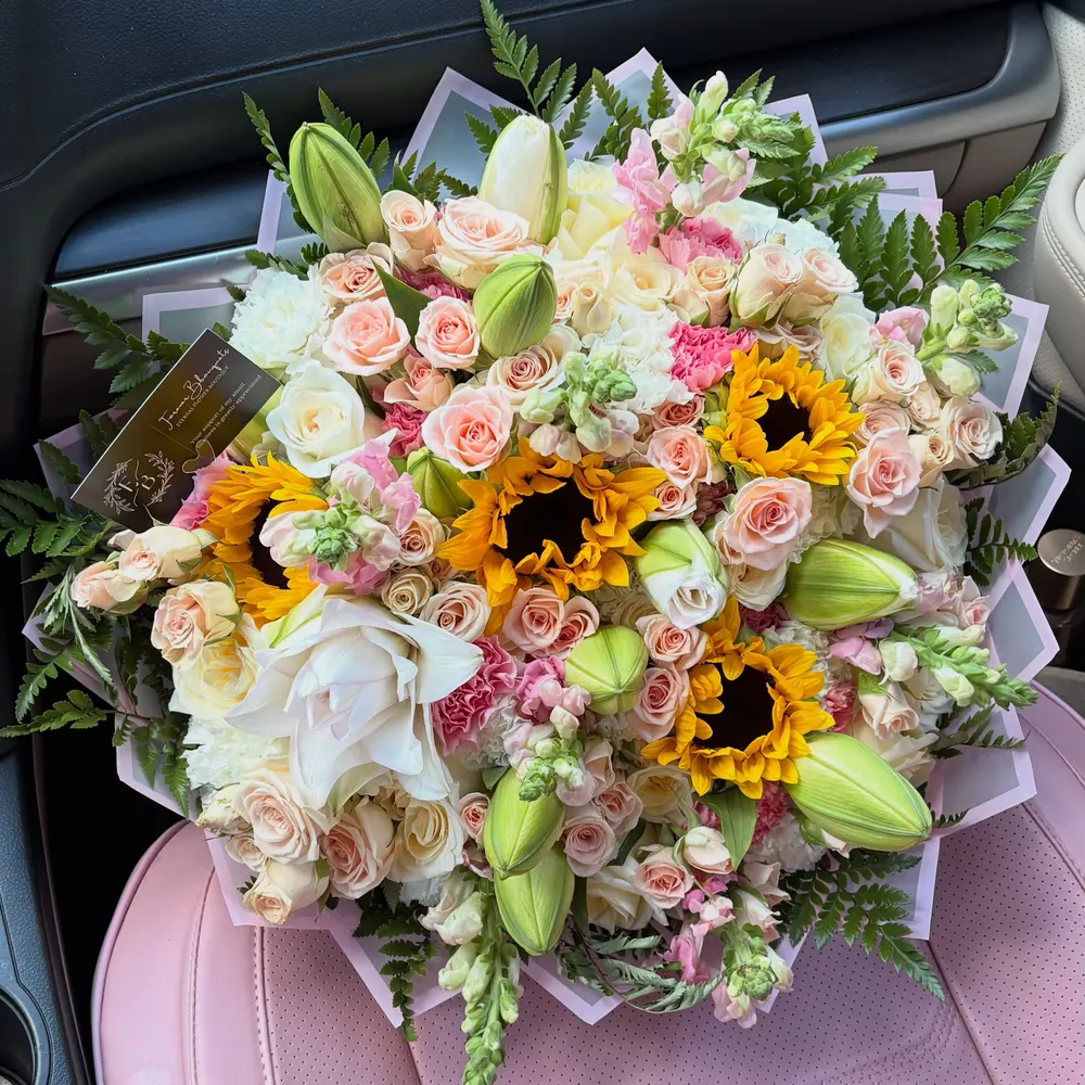Mixed bouquet with sunflowers, lilies and blush roses